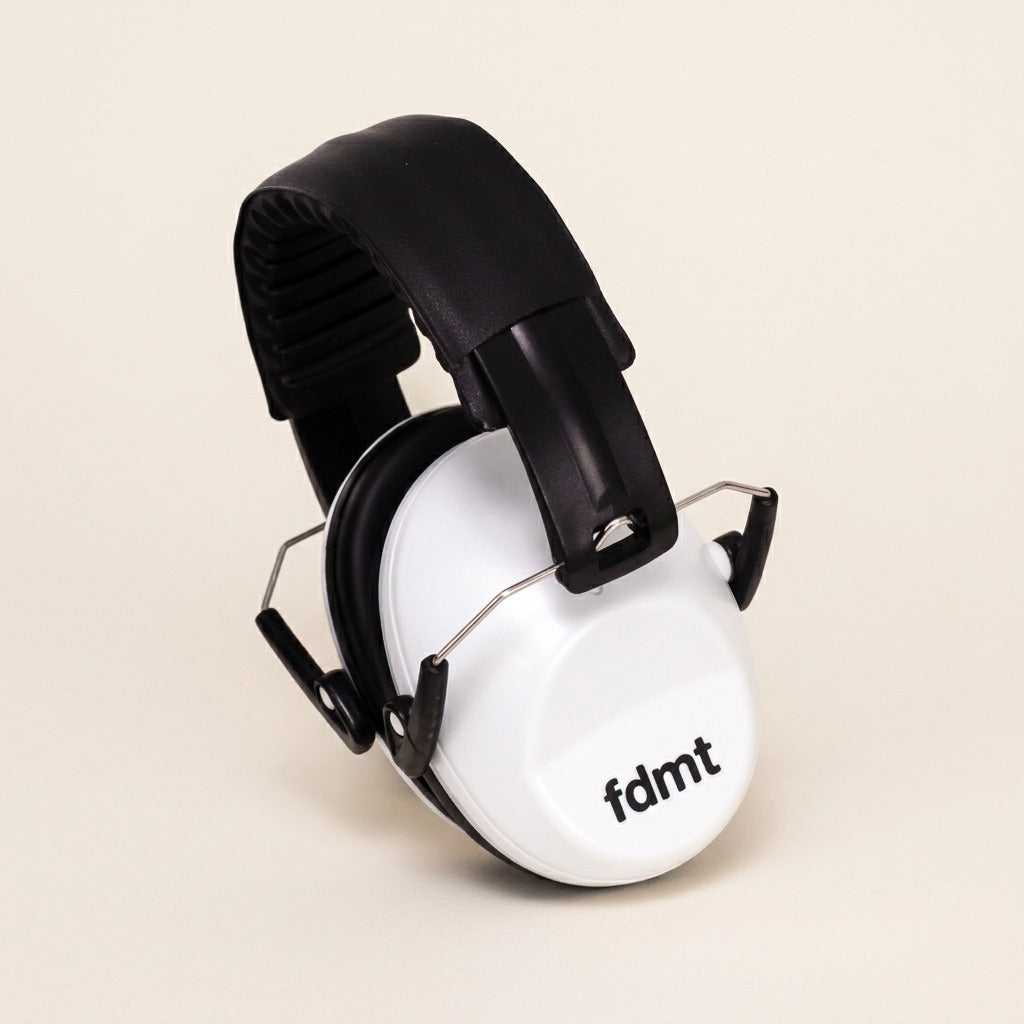 fdmt noise-reducing earmuffs in white with a padded black adjustable headband on a neutral background.